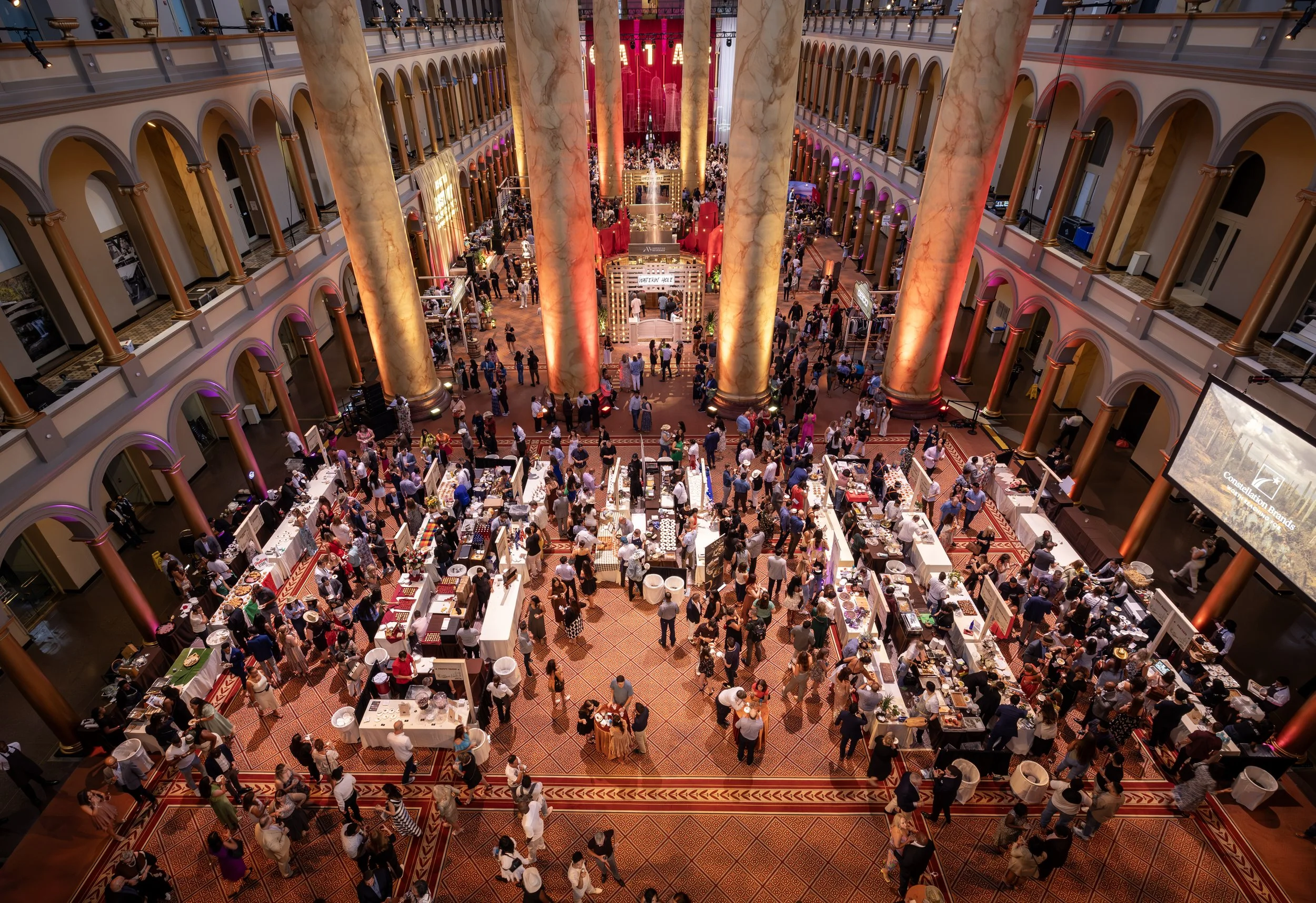 Event attendees pass between tables and pillars at the Best of Wasington event presented by Washingtonian Magazine.
