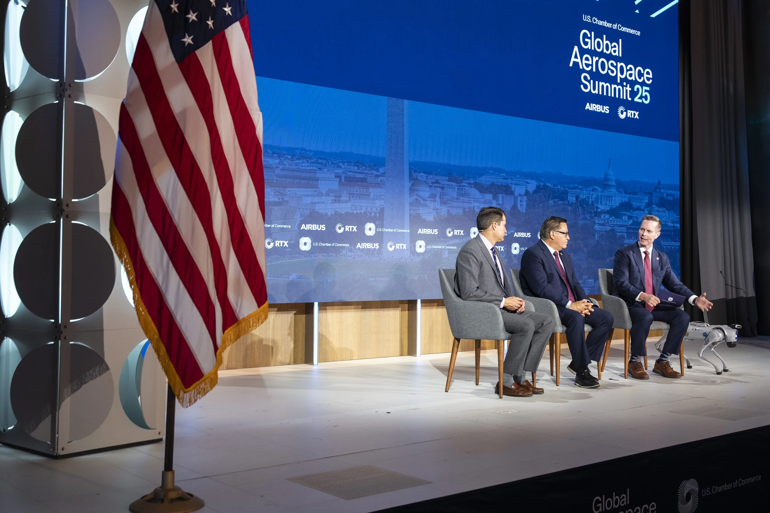 Three people sitting onstage at the 2025 Global Aerospace Summit. Photo © U.S. Chamber of Commerce.