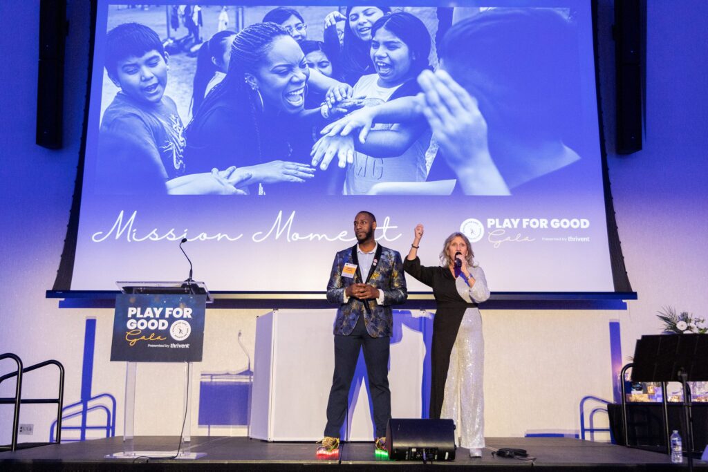 Two people onstage at the 2025 Play for Good Gala