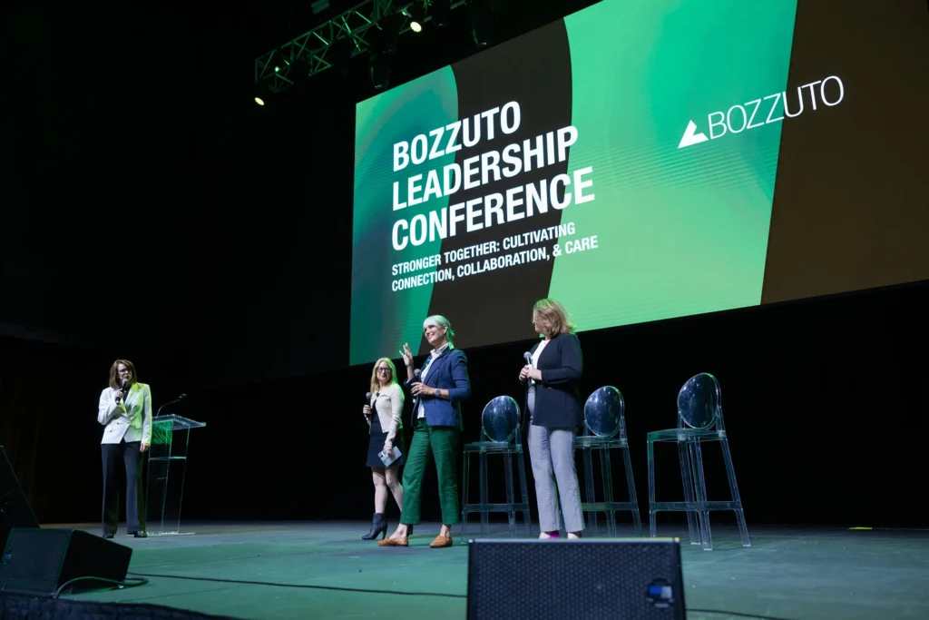 Four women from Bozzuto real estate leadership on stage at the Bozzuto Leadership Conference, an event produced by event production company Stratus Firm