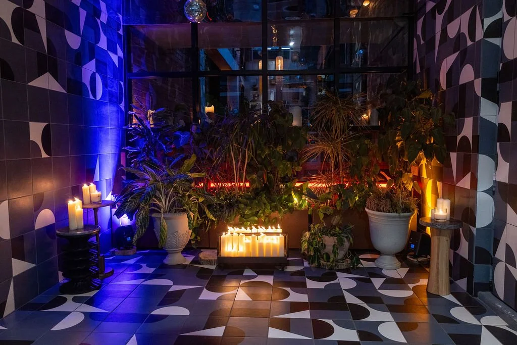 Greenery and candles in a tiled space