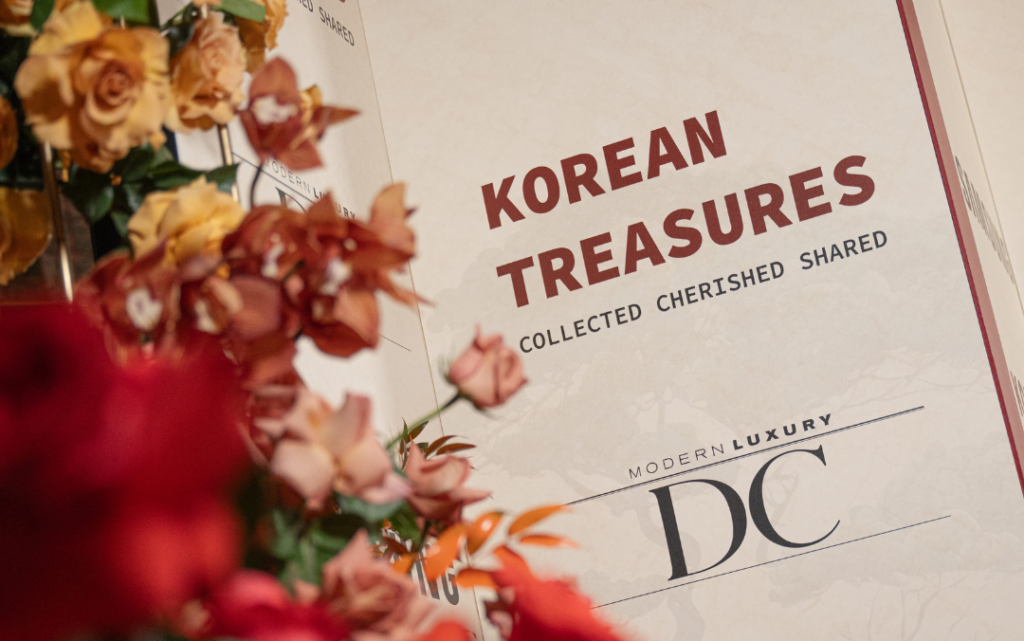 A sign reading "Korean Treasures: Collected, Cherished, Shared" with the Modern Luxury DC logo beneath it