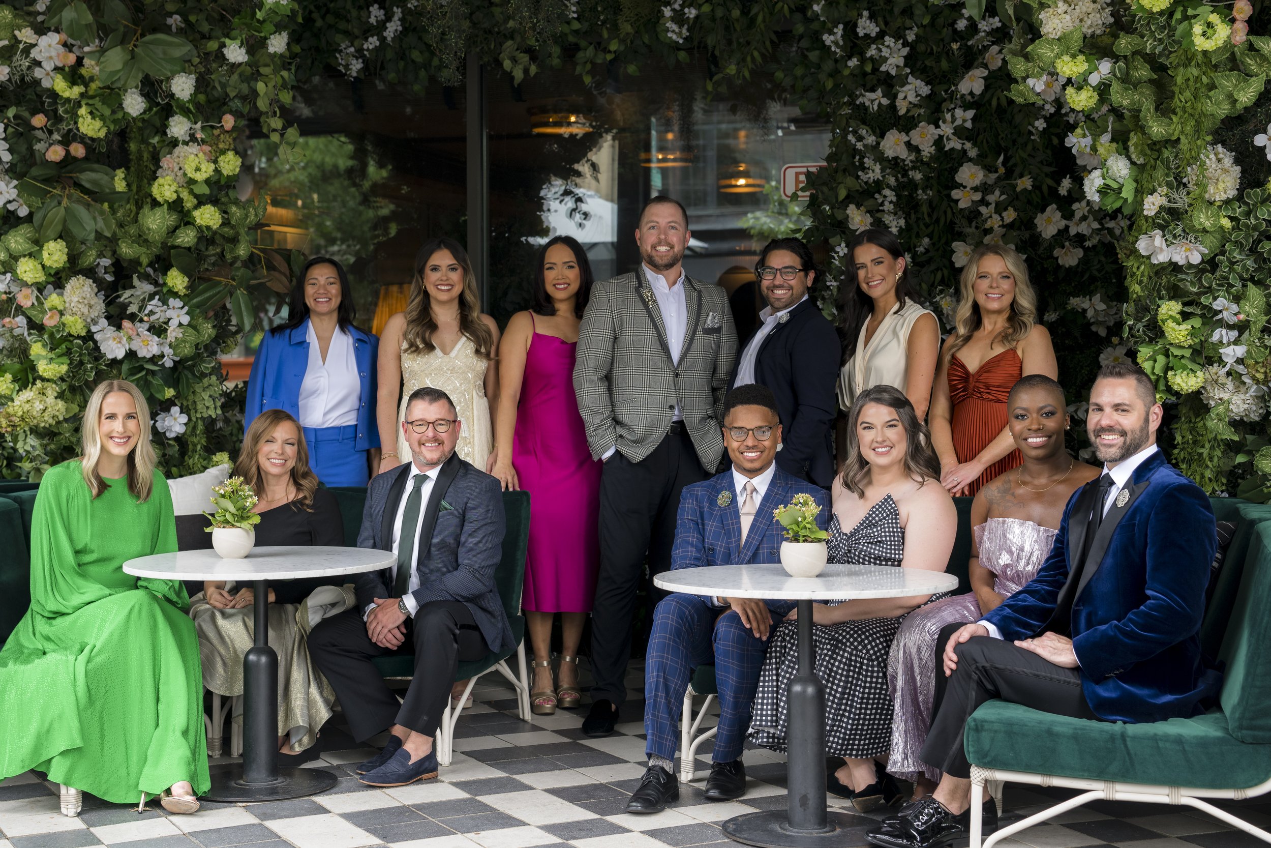 The full Stratus Firm team, seated on a patio surrounded by plants.