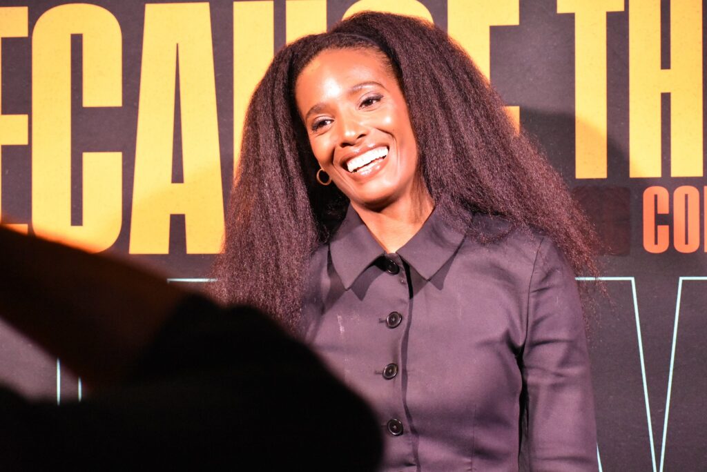 A woman poses for photos at the 2025 "Because They're Funny" Comedy Festival