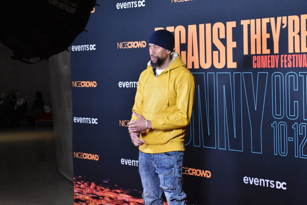 A man poses for photos at the 2025 "Because They're Funny" Comedy Festival