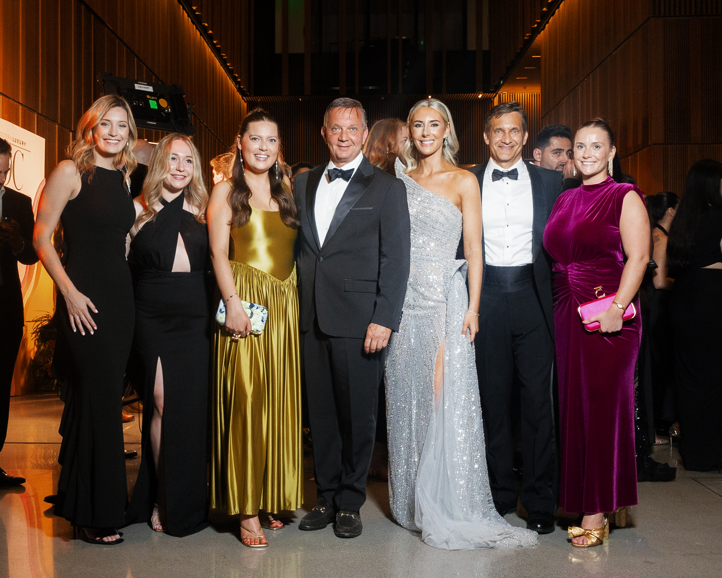 The DC Modern Luxury team, dressed elegantly in evening wear.