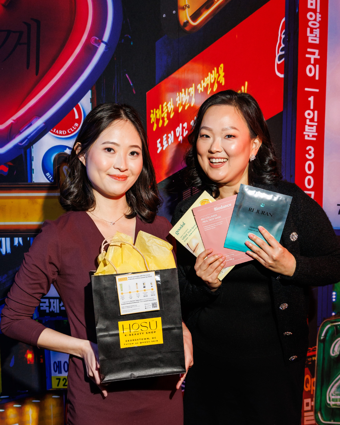 Two women hold up products from Hosu Beauty