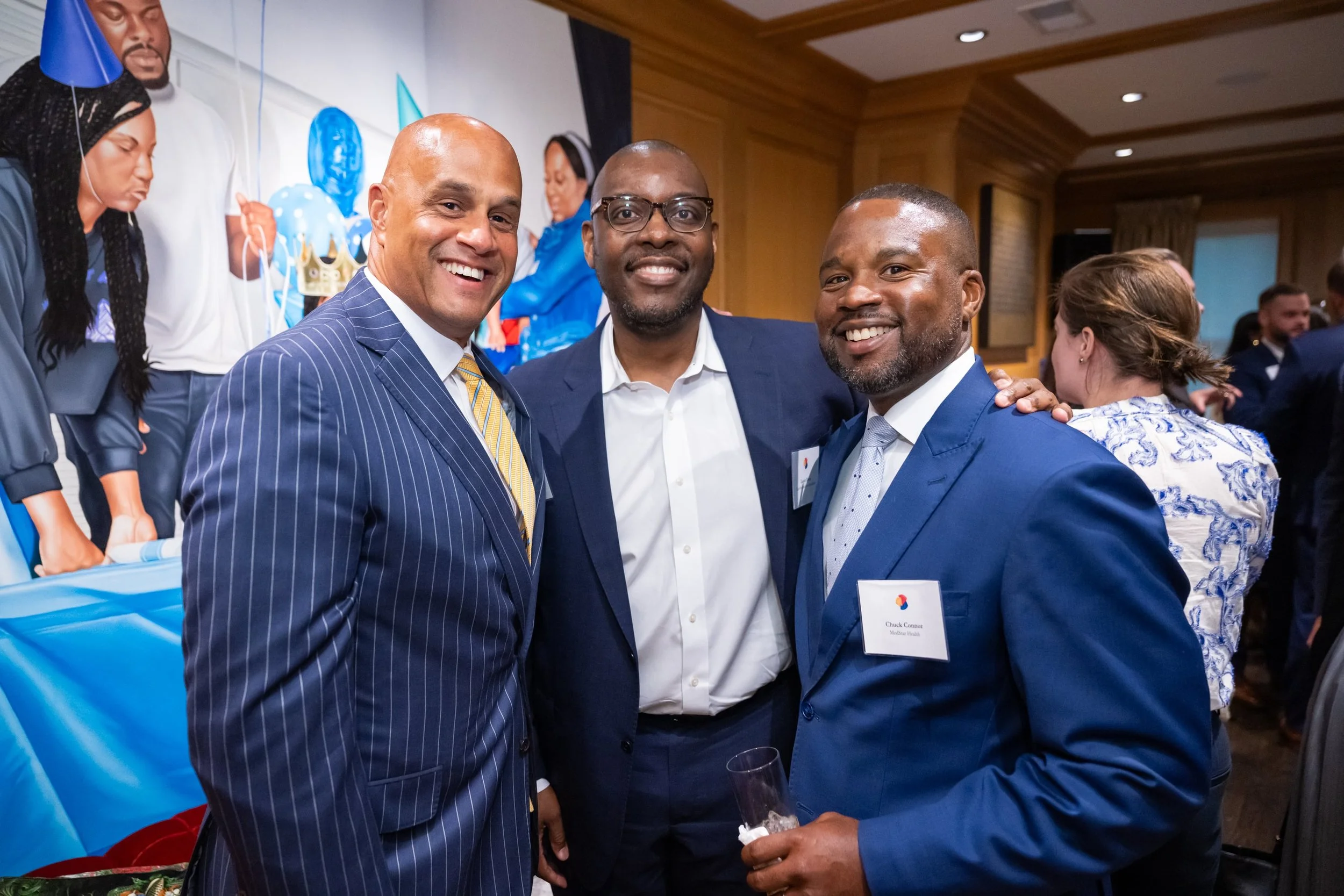 Three men smiling during a corporate meeting event. Event produced by Stratus Firm, an event agency located in Washington, DC.