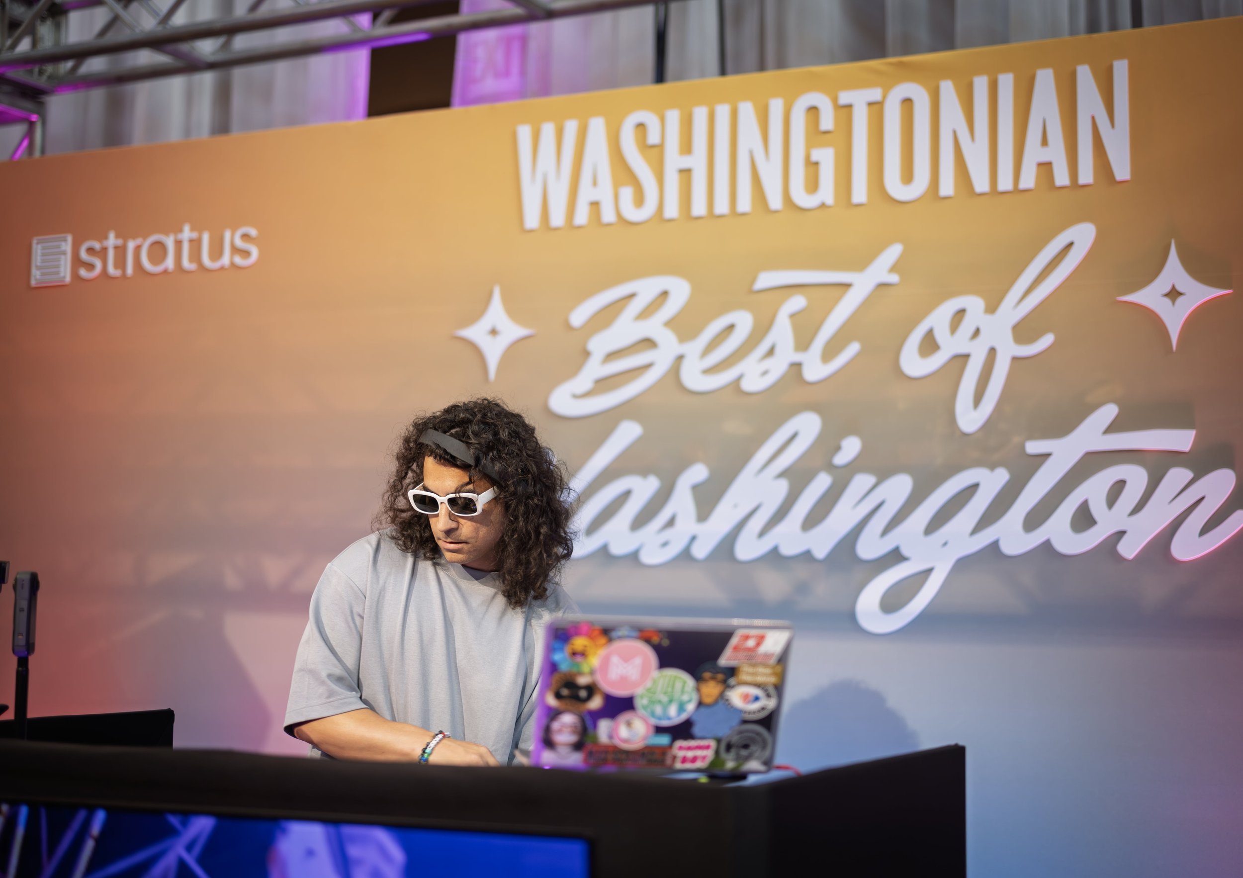 Male DJ behind booth during Washingtonian Magazine's Best of Washington 2025 event produced by Stratus Firm, an event production company located in DC