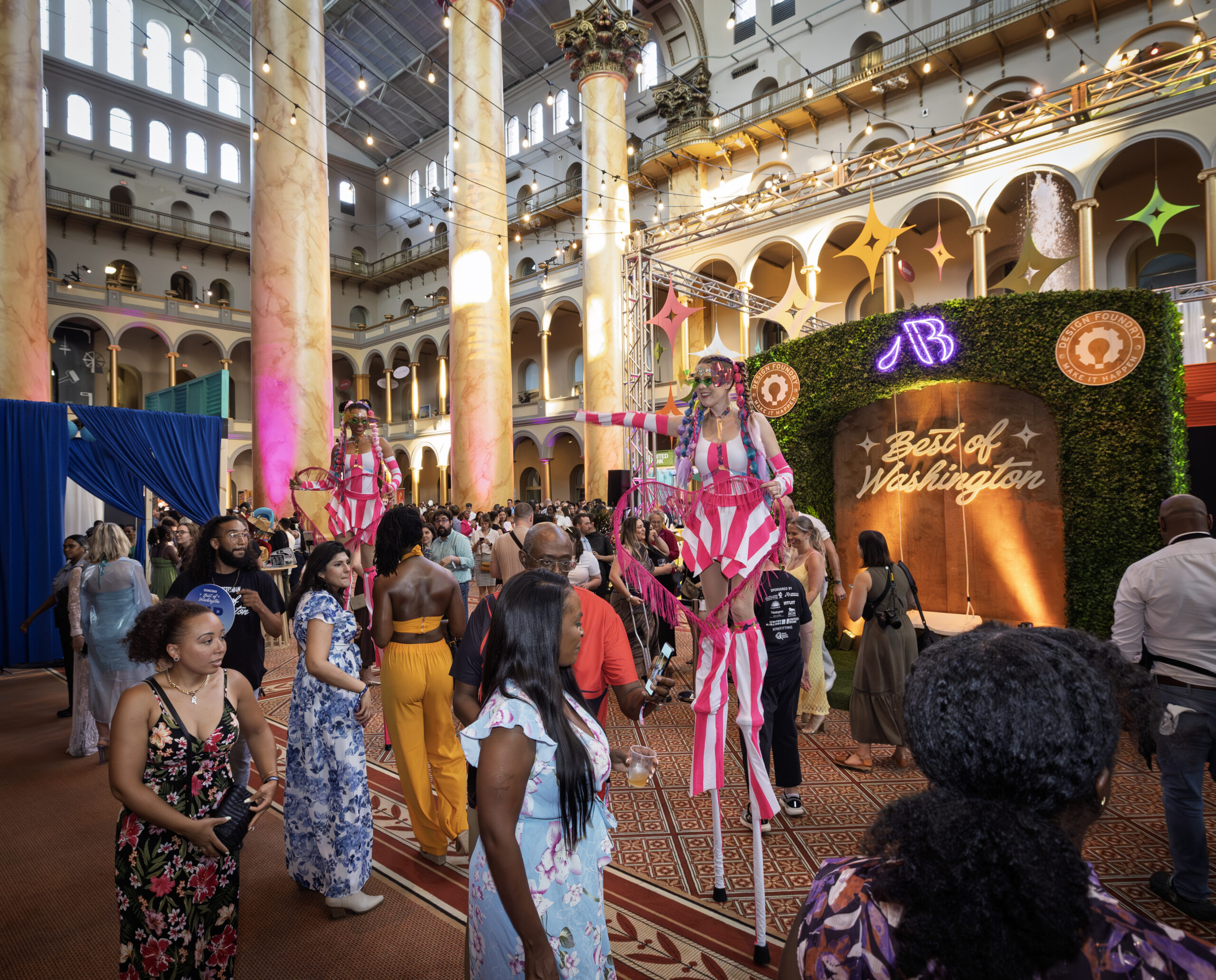 Two colorful stiltwalkers delight the crowd at the Best of Washington event.