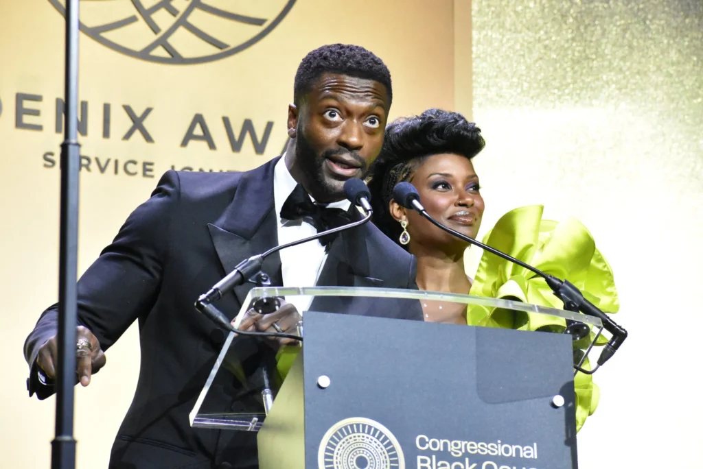 Male and Female presenters on stage behind a lecturn during the CBCF Phoenix Awards Dinner 2025, an event produced by Stratus Firm, an event production company located in Washington, DC