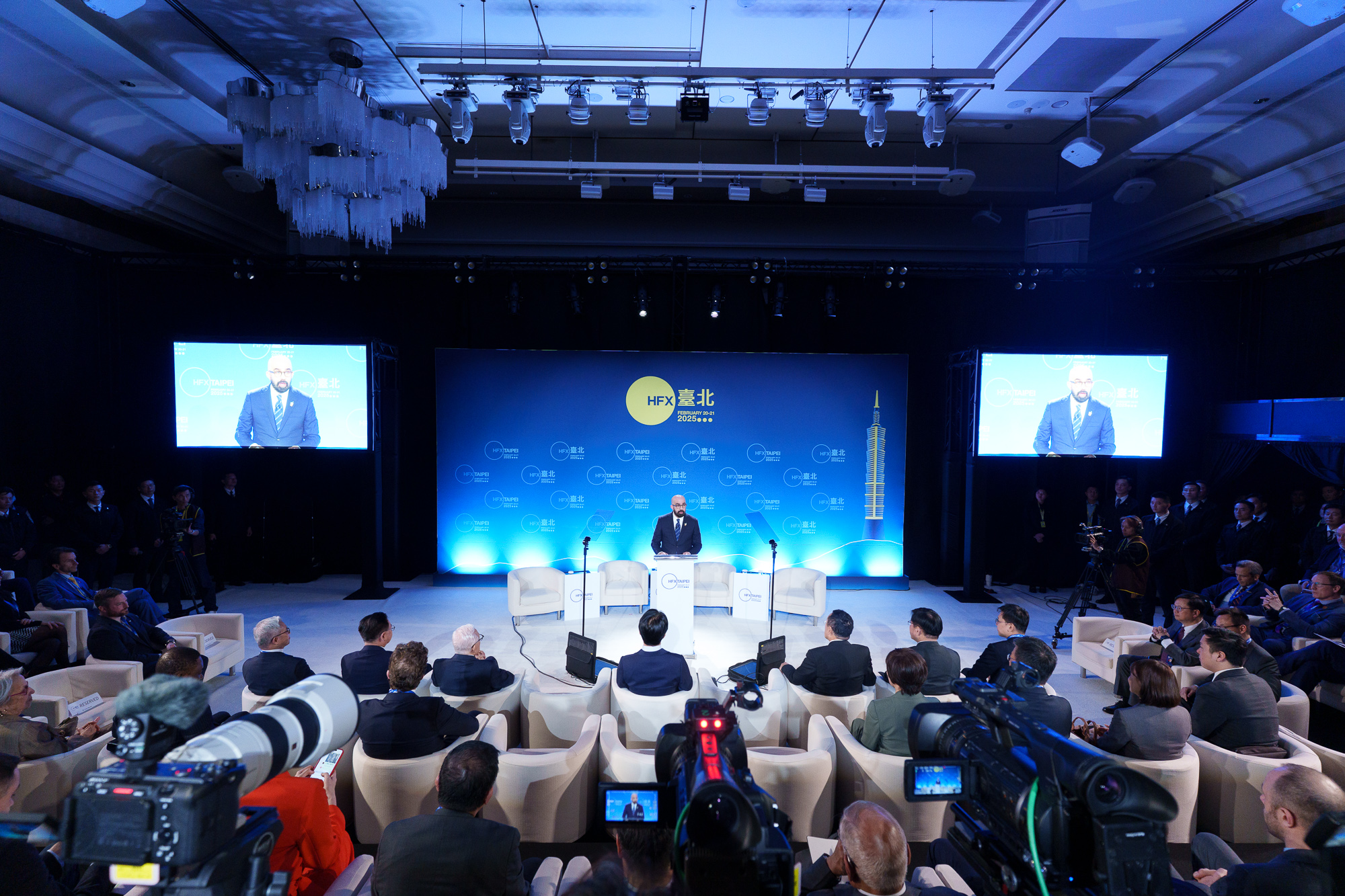 A speaker at a podium addresses the room during the Halifax International Security Forum.