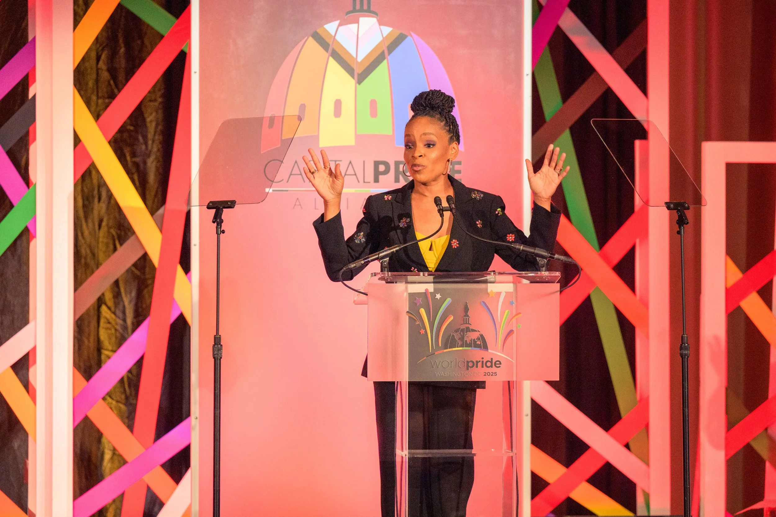 A woman speaks onstage at Capital Pride Alliance's 2025 World Pride Honors event.