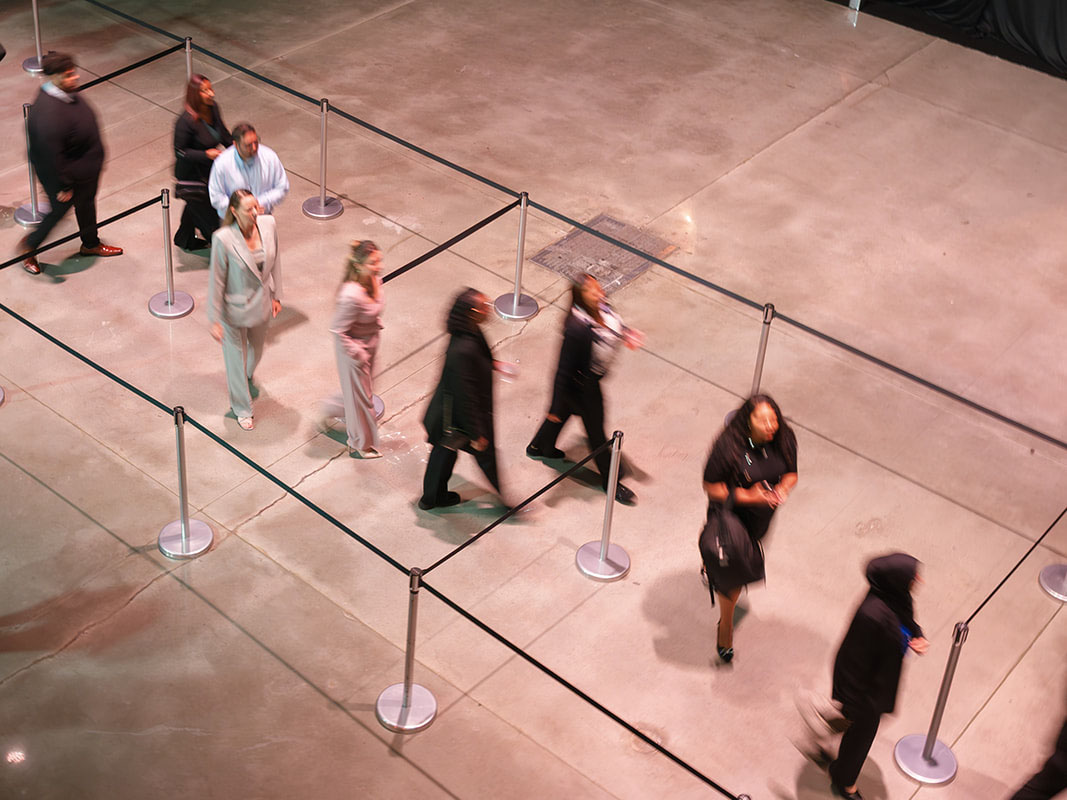 People move through a single-file line at an event.
