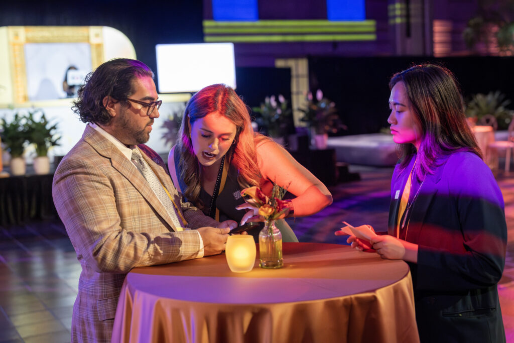 A Stratus intern assists at a table during an event.